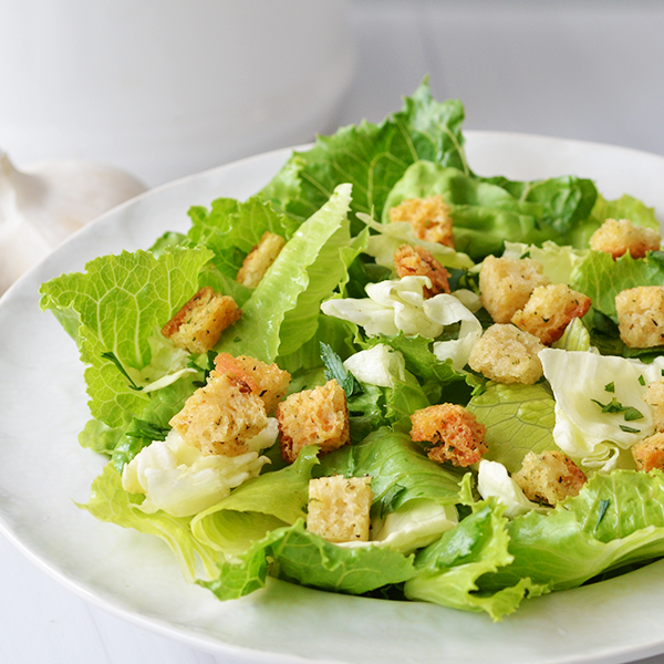 A prepared salad topped with Aleia's Gluten-Free Garlic Salad Croutons image